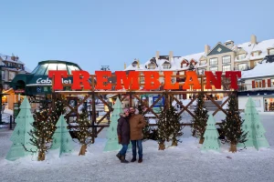 people standing in front of the Tremblant sign