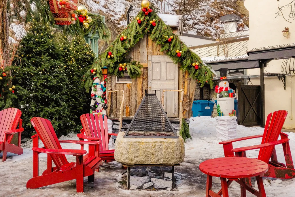 Christmas decoration in Quebec City, Adirondack chairs surrounding a fire pit and decorated housed