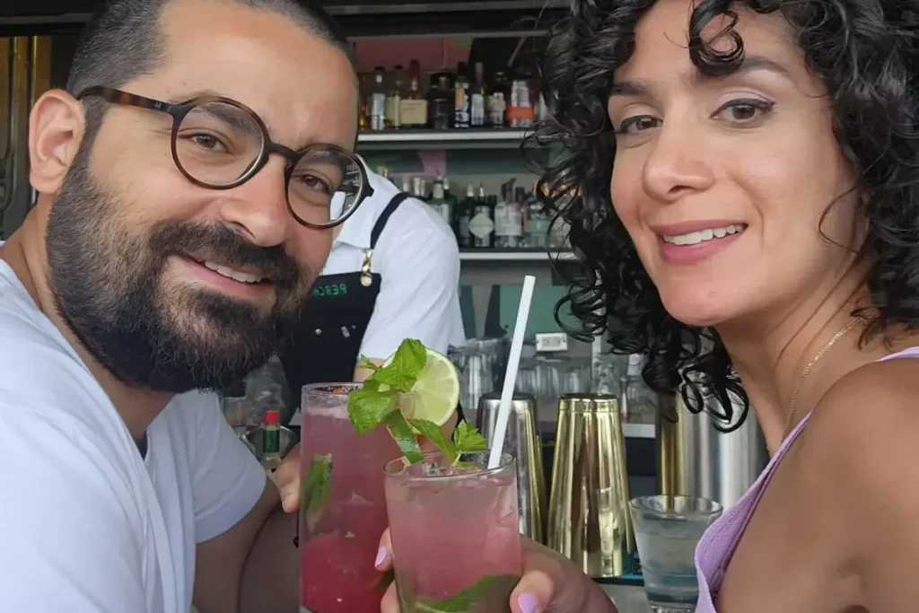 a couple on a date in a bar holding drinks