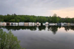 reflection of booat houses on the magog river